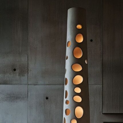 SCULPTURAL CONCRETE LIGHT TOWER WITH CUTOUT DESIGN