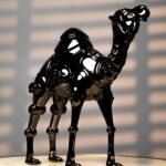 Black Camel Art Sculpture — glossy black resin animal sculpture in a modern avant-garde design, available as a single piece or set of two | Lume Art Gallery