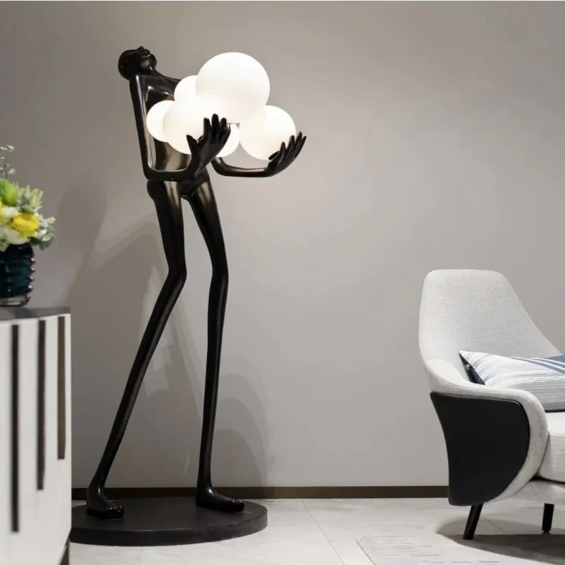 Modern sculpture floor lamp with human figure holding light orbs in contemporary living room