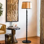 Arc floor lamp positioned behind corner sofa in contemporary living room with warm ambient lighting