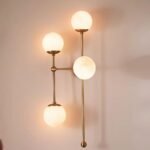 ARMSTRONG FOUR-LIGHT BRASS AND GLASS SCONCE WALL LIGHT