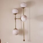 ARMSTRONG FOUR-LIGHT BRASS AND GLASS WALL SCONCE