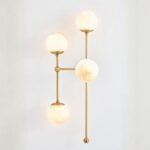 ARMSTRONG FOUR-LIGHT WALL SCONCE WITH BRASS AND GLASS