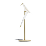 PERCH TABLE LIGHT BY UMUT YAMAC with single white origami paper bird perched on slim brass stem and round gold base, swivel design