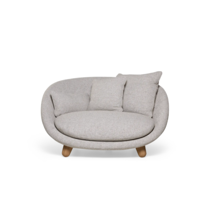 LOVE SOFA BY MARCEL WANDERS in cream boucle with rounded enveloping arms and wooden legs styled in a designer living space
