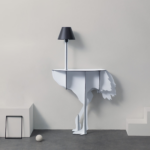 WHITE OSTRICH WALL LAMP by Rachel & Benoît Convers — flat cut white ostrich body with slim pole and dark lamp shade, styled in a minimal grey interior with geometric props