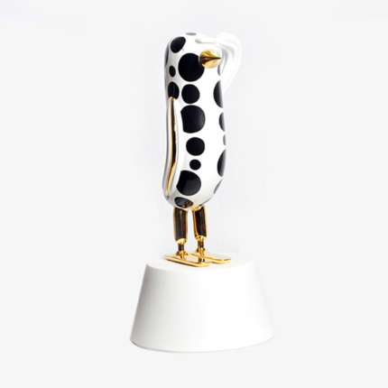 DOTS HOPE BIRD BY JAIME HAYON — white ceramic bird sculpture with black polka dots and 24-karat gold beak, legs, and feet on white pedestal.