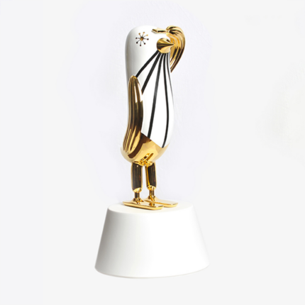 GOLD HOPE BIRD BY JAIME HAYON — glossy gold ceramic bird sculpture with flowing black line detail, starburst motif, and 24K gold on white pedestal.