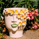 FRANGIPANI SCULPTURE CERAMIC VASE with hand-applied orange Plumeria flower crown and green painted lips