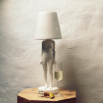 HIDING LADY TABLE LAMP BY MINKE VAN VOORTHUIZEN with tapered white cone shade replacing the head