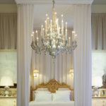 LOUIS XIV 36 LIGHT CHANDELIER WHITE in crisp white with floral motifs and candle-style arms, suspended in a luxury bedroom, handmade in Italy