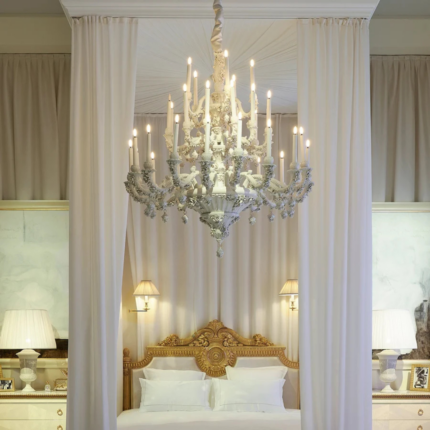 LOUIS XIV 36 LIGHT CHANDELIER WHITE in crisp white with floral motifs and candle-style arms, suspended in a luxury bedroom, handmade in Italy