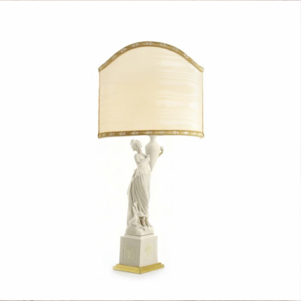 CLIZIA TABLE LAMP WHITE with a classical female figurine holding an amphora on a gold-accented square pedestal, with arched cream silk shade