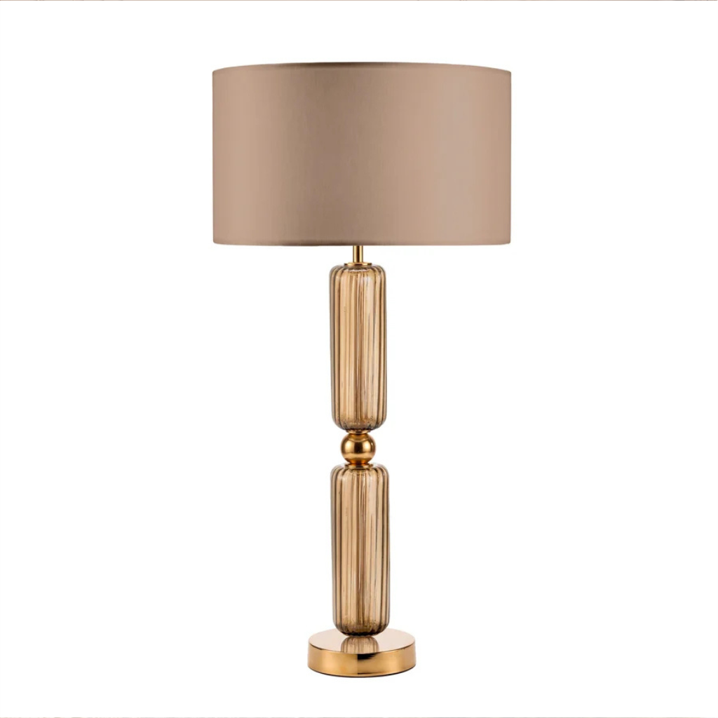 MONICA B TABLE LAMP TABACCO GOLD with two stacked fluted amber Murano glass cylinders, polished gold ball connector, disc base, and taupe drum shade MONICA B TABLE LAMP TABACCO GOLD with two stacked fluted amber Murano glass cylinders, polished gold ball connector, disc base, and taupe drum shade